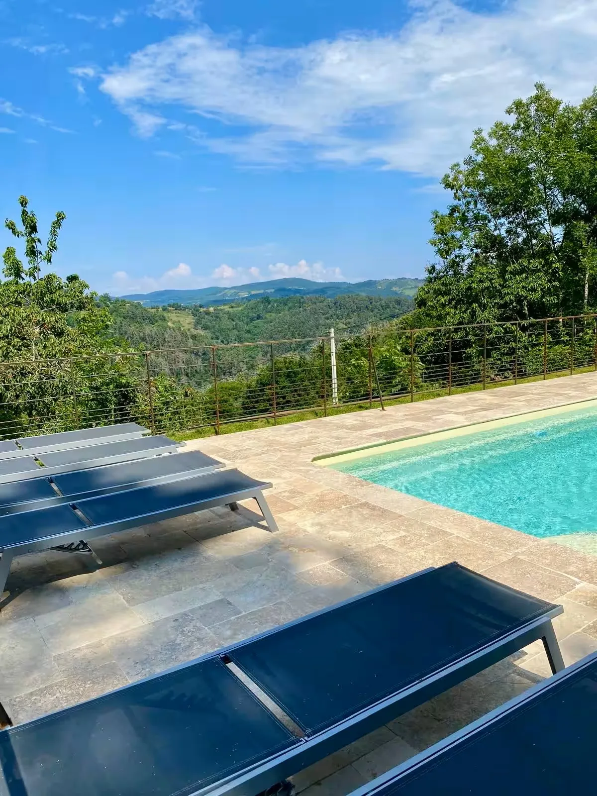 Transats près de la piscine avec vue sur les collines